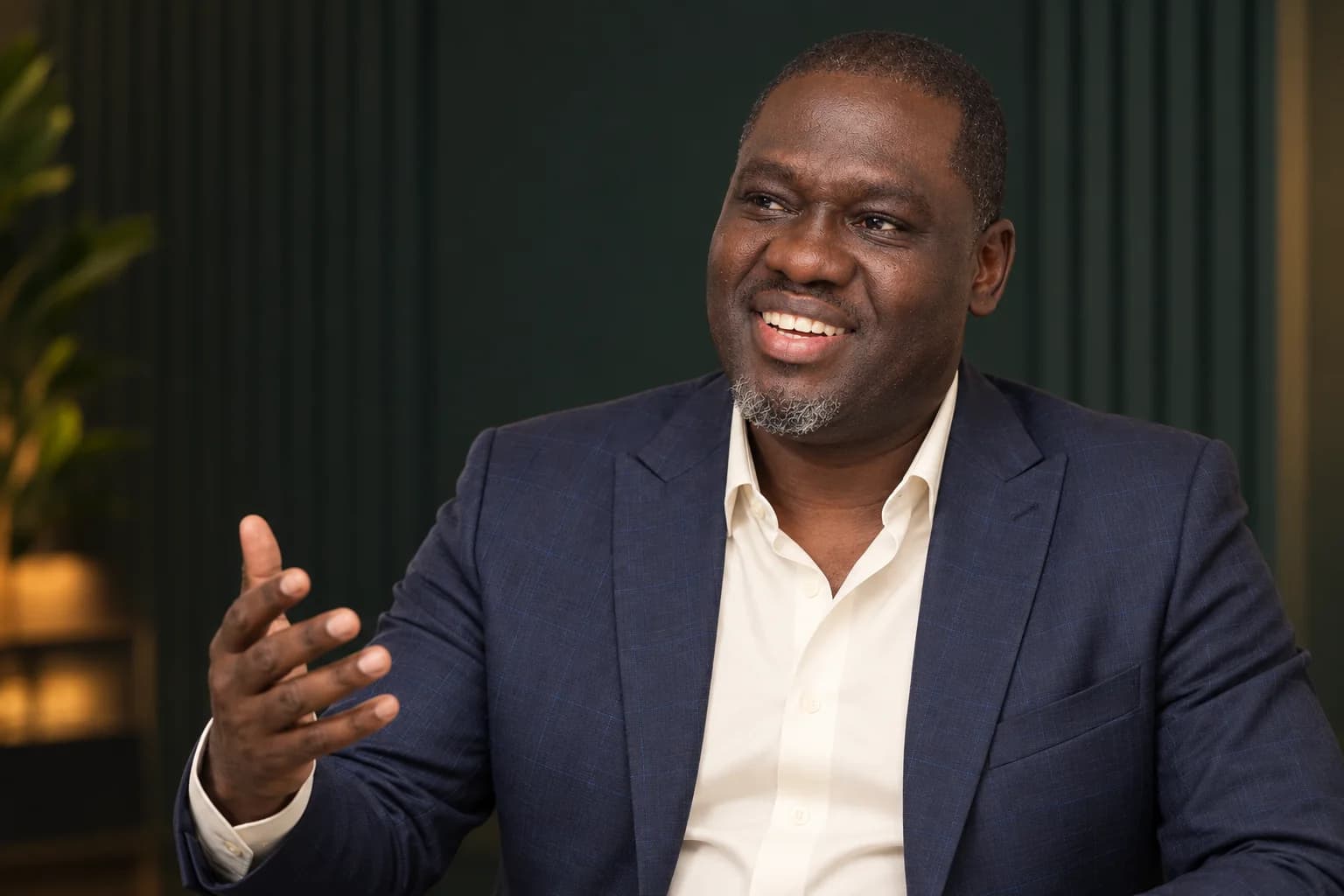 Illustrative editorial portrait of Ayodeji Peter Falope speaking
